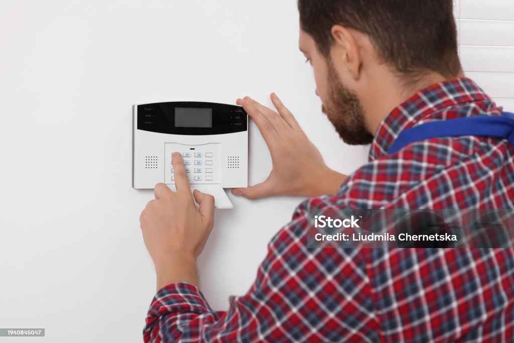 Entering Code Man Entering Code On Security Alarm System At Home Stock Photo ...