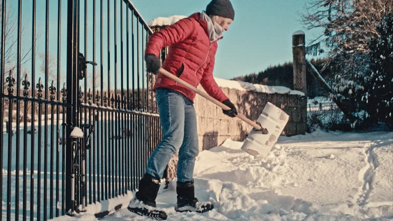 Woman using snow shovel