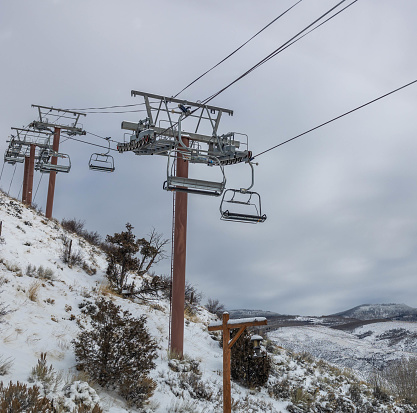 The way around in the mountains of Colorado. Ski lift  crossing over above the street in the luxury resort area of Beaver Creek, in Avon Colorado. Summit County.  Frisco, Vail, Breckenridge area.