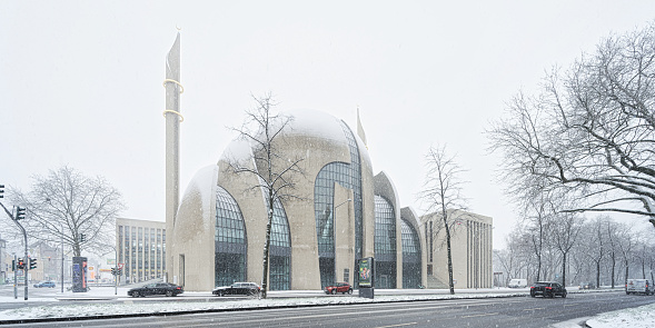 Cologne, Germany January 17 2024: snowfall and snow-covered central mosque in cologne ehrenfeld