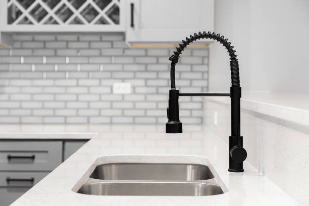 istock A black kitchen faucet detail in a grey kitchen. 1941007447