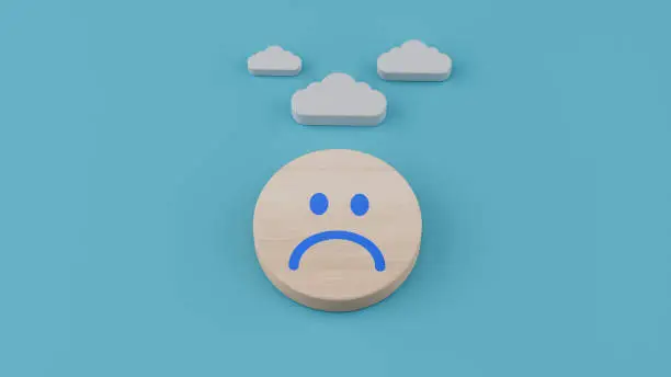 Sad smiley face emoticon with hanging cloud above the head, depressed mental health concept