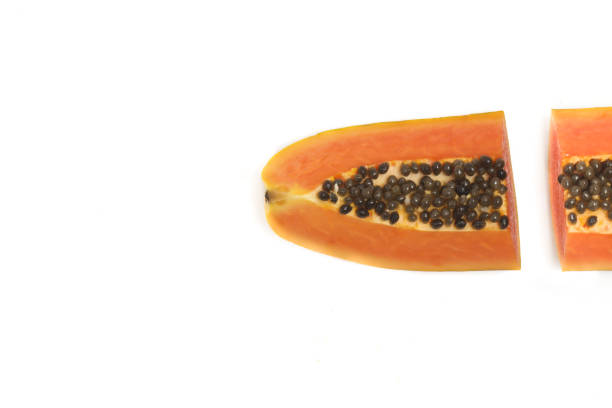Two half cut sliced fresh organic papaya delicious fruit top view isolated on white background clipping path