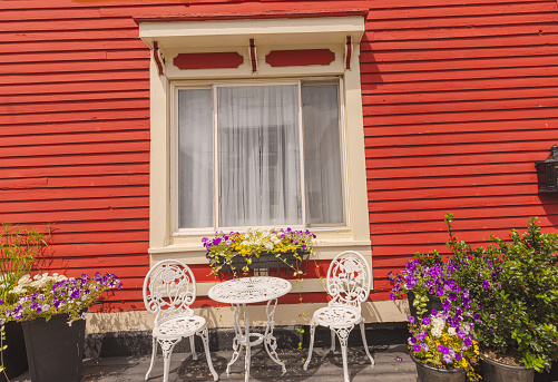 Some of the colourful jellybean row houses in St. John's Newfoundland and Labrador. An inviting place to sit among the flowers.