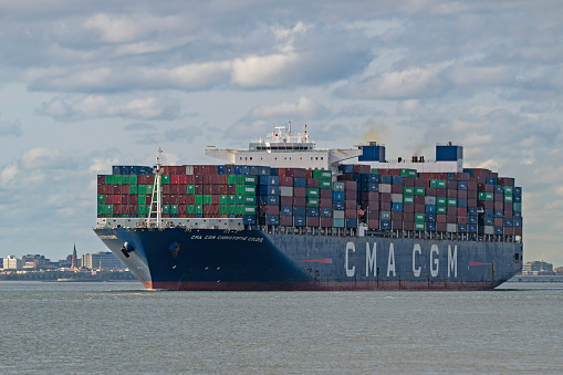 Charleston, SC, USA - January 17, 2024: The 366-meter Explorer Class container vessel CMA CGM Christopher Columbus sails out of Charleston Harbor.