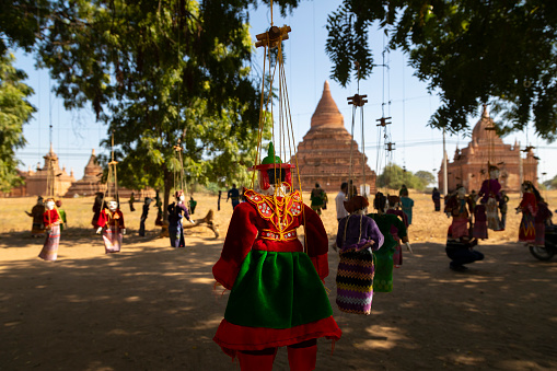 Bagan, Myanmar - 25 Dec, 2019: Ornate puppets, dressed in traditional Burmese fashion, hang from strings in Bagan, Burma