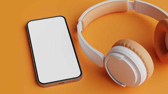 Mockup of white wireless headphones and smartphone screen on orange colored background,3d rendering