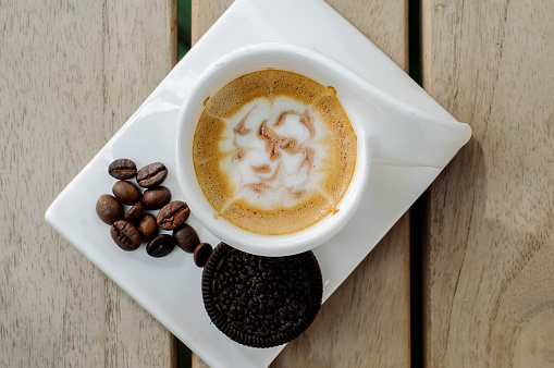 Espresso macchiato is made by adding a little milk and garnished by cookies