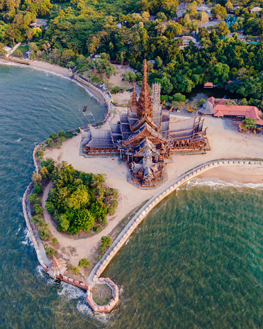 The Sanctuary of Truth wooden temple in Pattaya Thailand, is a gigantic wooden construction located at the cape of Naklua Pattaya City Chonburi Thailand at sunset