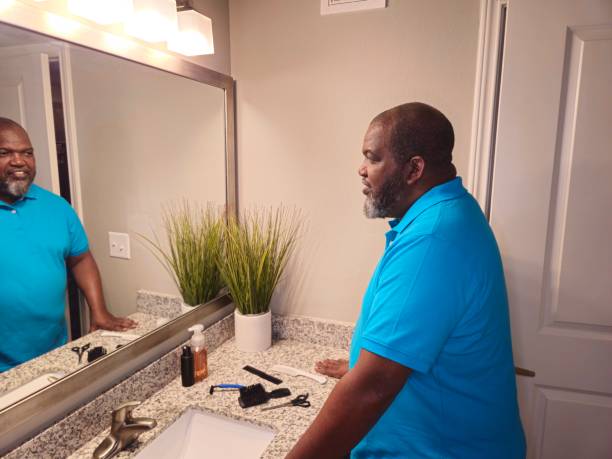 istock Personal Care Black Male Looking Into Mirror 1941258148