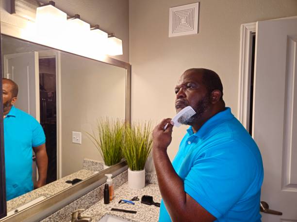 istock Personal Care Black Male Combing Beard With White Comb 1941258666