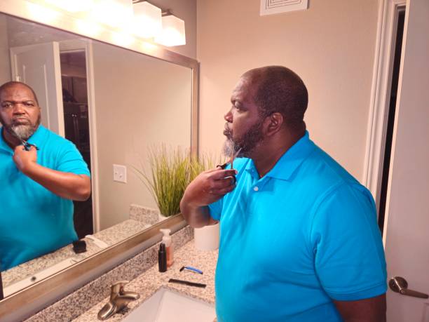 istock Personal Care Black Male Trimming Beard With Scissors 1941258669