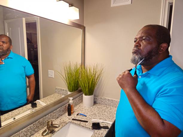istock Personal Care Black Male Trimming Beard With Scissors 1941258687