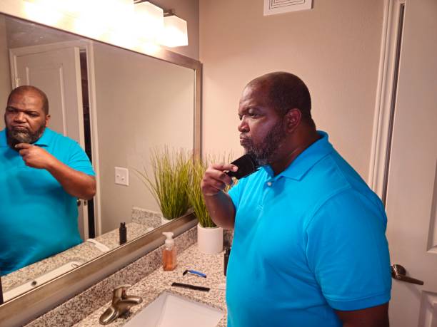 istock Personal Care Black Male Brushing Beard With Black Brush 1941258688