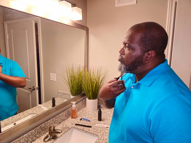 istock Personal Care Black Male Trimming Beard With Scissors 1941259199