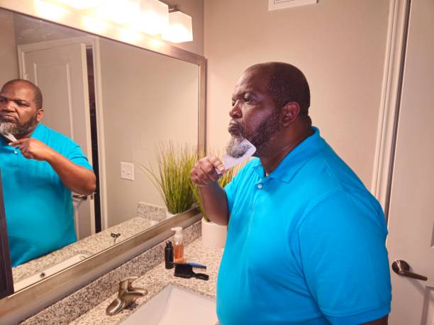 istock Personal Care Black Male Combing Beard With White Comb 1941260235