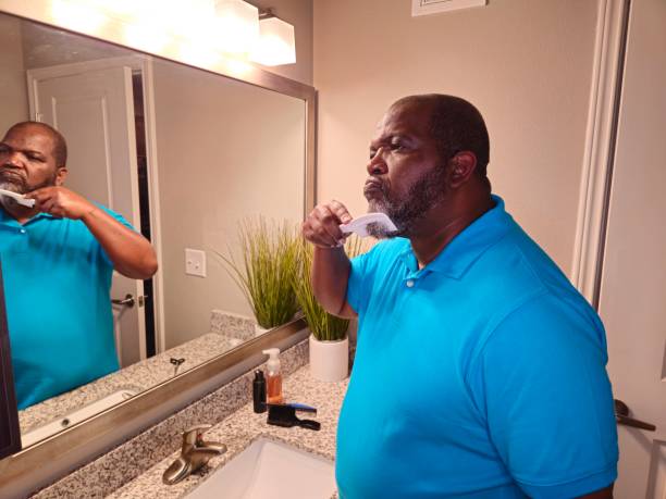 istock Personal Care Black Male Combing Beard With White Comb 1941260242