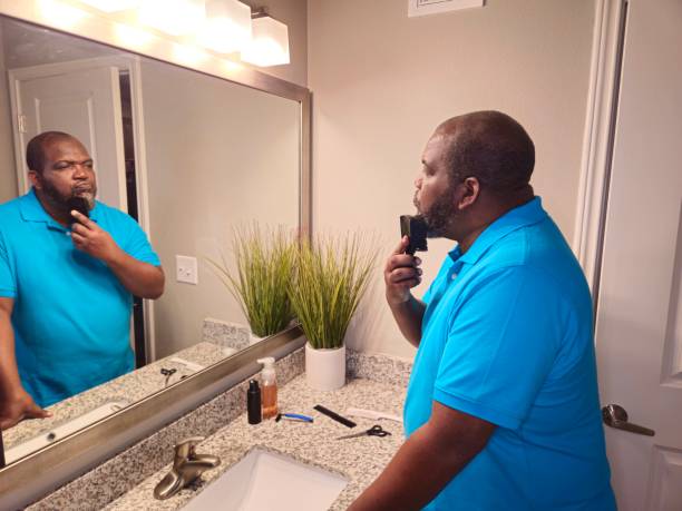 istock Personal Care Black Male Brushing Beard With Black Brush 1941260535