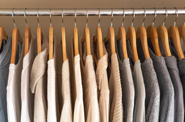 istock Hanger with neutral beige and white clothes on a white background. 1941264372