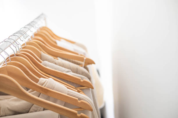 istock Hanger with neutral beige and white clothes on a white background. 1941288875