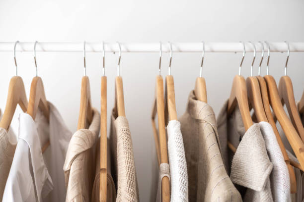 istock Hanger with neutral beige and white clothes on a white background. 1941288931