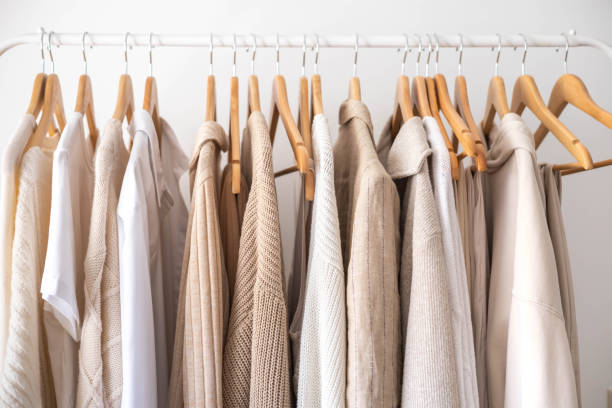 istock Hanger with neutral beige and white clothes on a white background. 1941289152