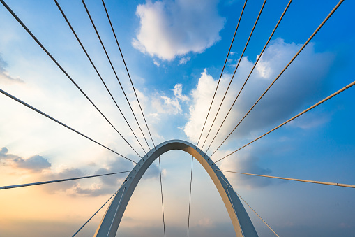 Wonderful white bridge structure over clear blue sky. Abstract detail