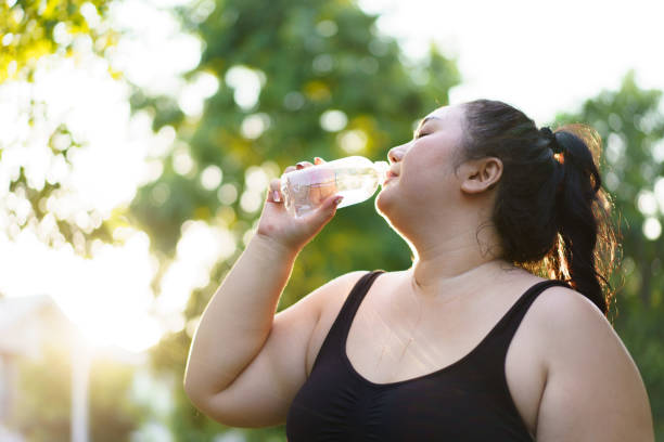 istock Fat woman making an outdoor exercise. 1941339089
