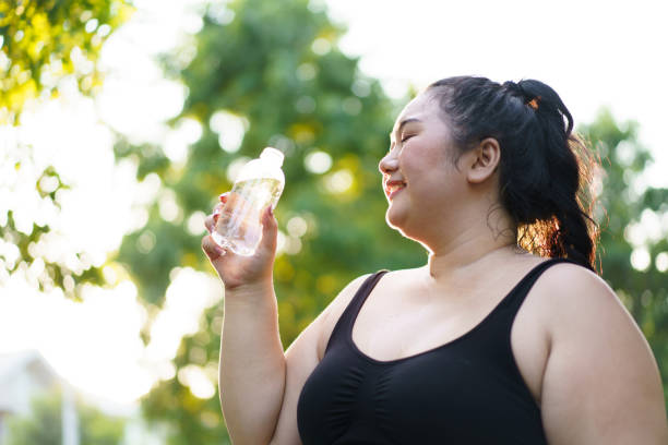 istock Fat woman making an outdoor exercise. 1941339093
