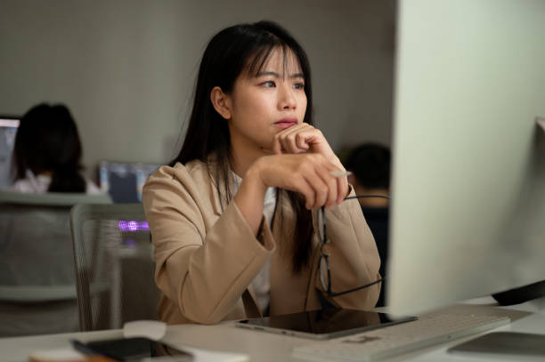 istock A dissatisfied businesswoman is reading emails, looking at her computer screen with a serious face. 1941344349