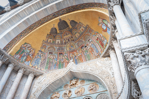 Venice Italy - May 11 2011; Religious mosaic scene in niche of arch on exterior of St Marks cathedral.