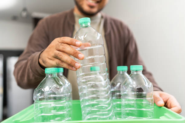 istock A young man arranged plastic bottles into a box. He assumes plastic bottles will sort of trash before throwing them into the bin. World environment day. Recycle waste reduce environmentally friendly 1941426765