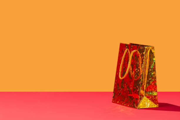 One Yellow bright gift paper shopping bag on yellow background. Copy space for text shadow