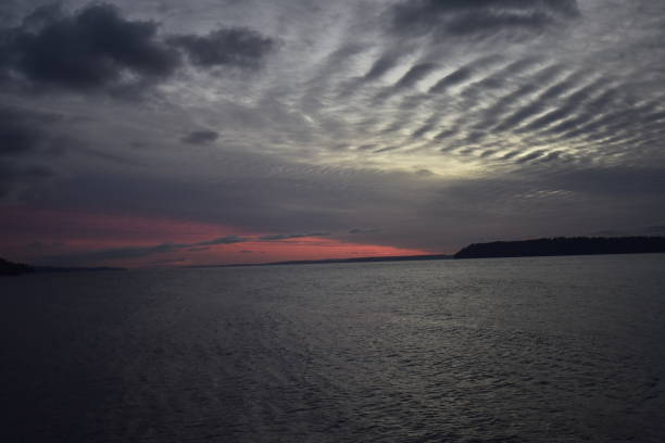 Sunset to the South The deepening of clouds of the next weather system streaming into Puget Sound sent all the cherry sunset rays to the south.  The glow could be seen for 15 miles. south puget sound stock pictures, royalty-free photos & images