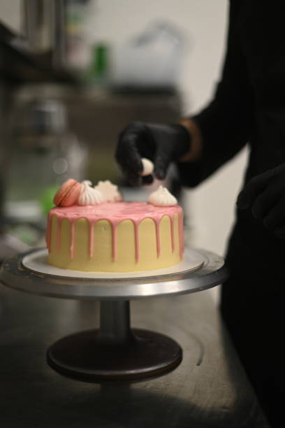 istock fresh frosted icing dripping pink vanilla birthday cake macaron decoration on top 1941547340
