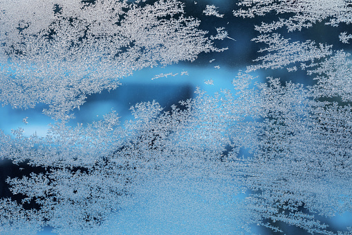 Frosty patterns on a frozen window, background