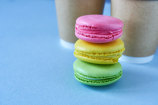 Colorful macaroons on blue background. Selective focus.