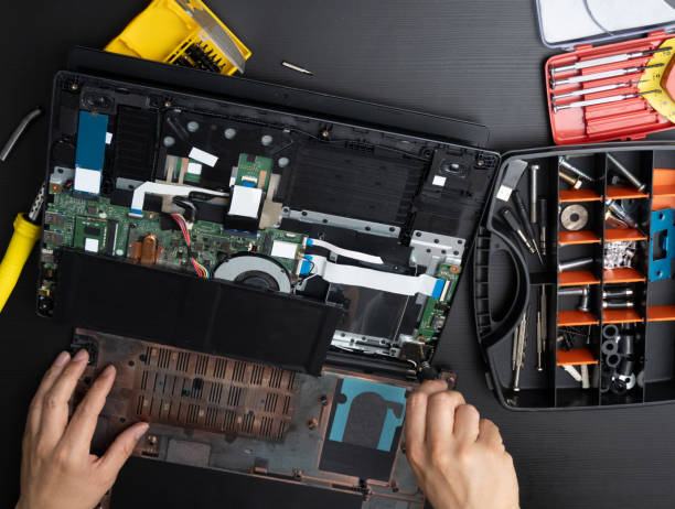 istock a person unscrewing a damaged computer to be repaired 1941597344