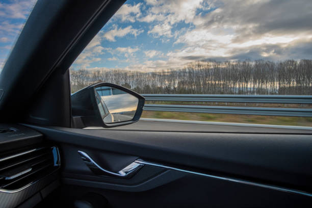 istock Right side window care view while driving on a highway fast on a cloudscape sky 1941625695