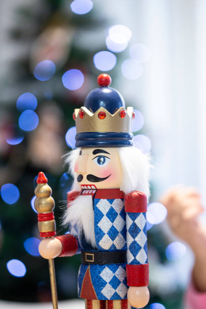 istock Cute nutcracker made of wood Christmas decoration in a blue spotlight pattern background 1941628887