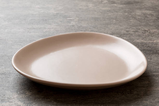istock Perspective view of empty pink plate on cement background. Empty space for your design 1941679419