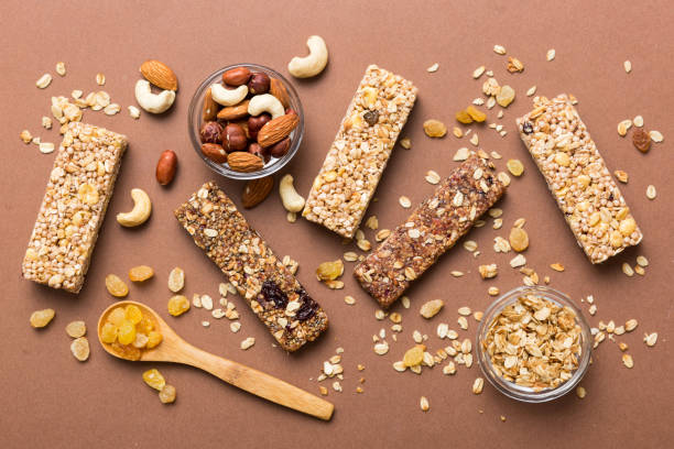 istock Various granola bars on table background. Cereal granola bars. Superfood breakfast bars with oats, nuts and berries, close up. Superfood concept 1941680583