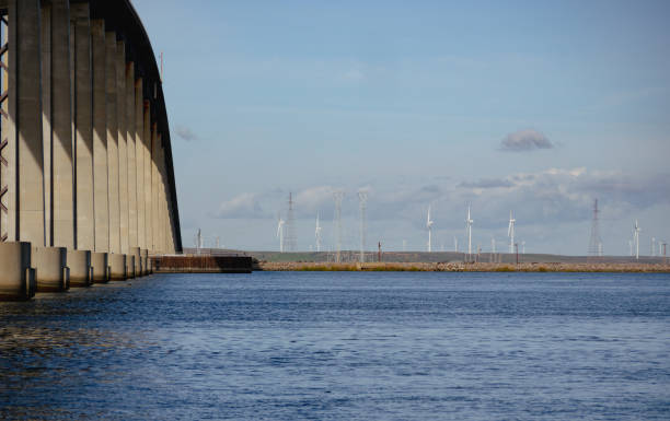 istock Concrete bridge over a lake against a bright blue sky 1941685301
