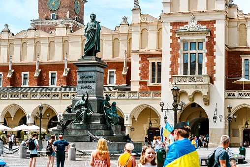 Krakow, Poland - August 12, 2023: Unveiled in 1898, the monument to Adam Mickiewicz, one of the most influential and significant figures in Polish poetry, adorns the city's main square.
