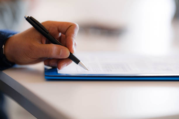 istock Close up of unrecognizable businessman working on reports. 1941700976