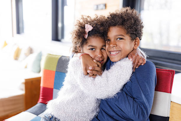 istock Embraced African American siblings enjoying at home. 1941715560