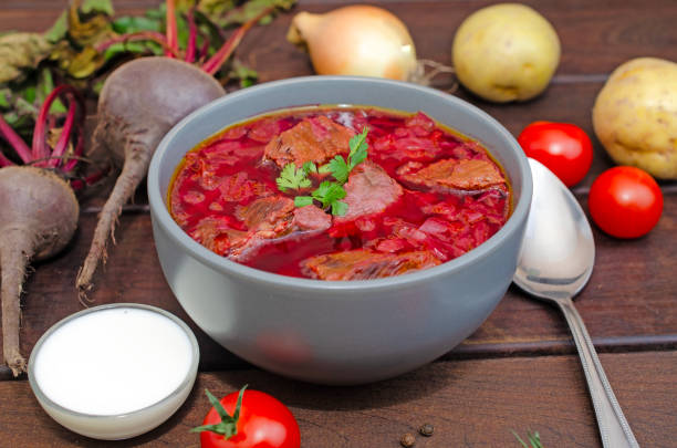 istock Borscht soup with vegetables and meat on a wooden table. 1941734616