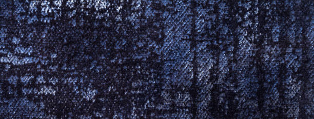 istock Texture of velvet navy blue background from soft upholstery textile material, macro. Abstract velour dark denim fabric 1941786553