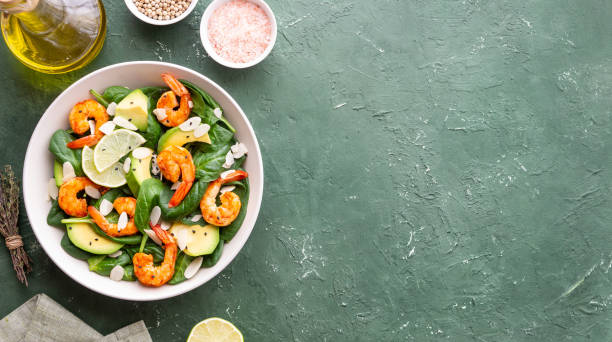 Salad with shrimps, avocado, spinach and almonds. Healthy eating. Diet. Salad with shrimps, avocado, spinach and almonds. Healthy eating Diet spring mix lettuce leaves stock pictures, royalty-free photos & images
