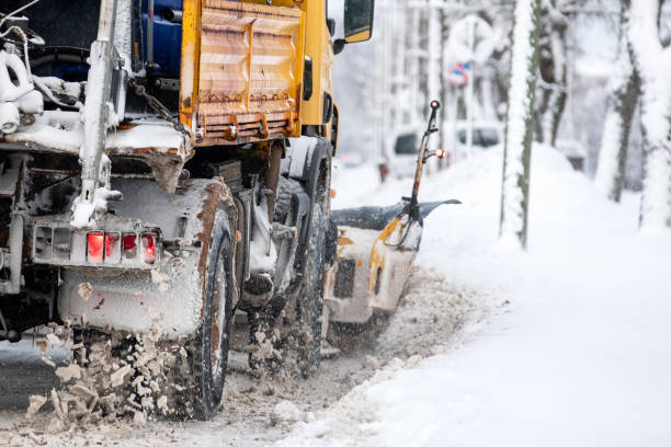 istock A snow-covered snowplow cleans the street after a snowfall, viw from back 1941832289